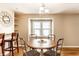 Dining area with hardwood floors, decorative mirror, and stylish chairs at 5119 Norwaldo Ave, Indianapolis, IN 46205