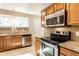 Kitchen featuring stainless steel appliances and stone countertops at 5119 Norwaldo Ave, Indianapolis, IN 46205