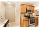 Charming kitchen with stainless steel oven/microwave, granite countertops, and ample cabinet space at 5119 Norwaldo Ave, Indianapolis, IN 46205