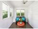 Sunroom with white shiplap walls, vibrant decor, and a cozy bench at 5119 Norwaldo Ave, Indianapolis, IN 46205