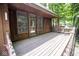 Covered porch with wood flooring, wood railing, and natural wood tones at 5530 Shawnee Trail South Dr, Indianapolis, IN 46220