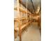 Unfinished basement featuring built-in shelving and concrete flooring at 5530 Shawnee Trail South Dr, Indianapolis, IN 46220