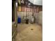 Unfinished basement with exposed pipes, concrete walls, and utility equipment at 5530 Shawnee Trail South Dr, Indianapolis, IN 46220