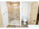Bathroom featuring a walk-in tile shower with glass door, toilet, and vanity at 5530 Shawnee Trail South Dr, Indianapolis, IN 46220