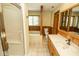 Bright bathroom featuring a glass shower, tub, tile floors, and wood paneling accents at 5530 Shawnee Trail South Dr, Indianapolis, IN 46220