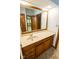 Bathroom featuring single sink vanity with wood cabinets and decorative tile flooring at 5530 Shawnee Trail South Dr, Indianapolis, IN 46220