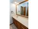 Bathroom featuring single sink vanity with wood cabinets and decorative tile flooring at 5530 Shawnee Trail South Dr, Indianapolis, IN 46220