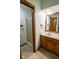 Bathroom featuring single sink vanity with wood cabinets, shower stall and decorative tile flooring at 5530 Shawnee Trail South Dr, Indianapolis, IN 46220