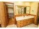 Bathroom vanity with wood cabinets and access to a closet at 5530 Shawnee Trail South Dr, Indianapolis, IN 46220