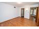 Bright bedroom with hardwood floors and a doorway to the bathroom at 5530 Shawnee Trail South Dr, Indianapolis, IN 46220