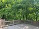 Spacious deck with wood railing overlooking the backyard at 5530 Shawnee Trail South Dr, Indianapolis, IN 46220