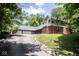Stately home featuring an extra long driveway, a brick and siding exterior, and mature trees at 5530 Shawnee Trail South Dr, Indianapolis, IN 46220