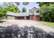 Well-maintained home with a long driveway, brick and siding exterior, and attached two car garage at 5530 Shawnee Trail South Dr, Indianapolis, IN 46220