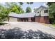Well-maintained home with a long driveway, brick and siding exterior, and attached two car garage at 5530 Shawnee Trail South Dr, Indianapolis, IN 46220