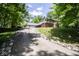 Stately home featuring an extra long driveway, a brick and siding exterior, and mature trees at 5530 Shawnee Trail South Dr, Indianapolis, IN 46220