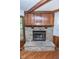 Close-up of a stone fireplace with a wood mantel and hearth at 5530 Shawnee Trail South Dr, Indianapolis, IN 46220