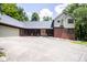 Charming home featuring a brick exterior, covered front entrance, and mature trees at 5530 Shawnee Trail South Dr, Indianapolis, IN 46220