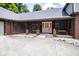 Inviting front entrance with covered porch and brick pillars offers a warm welcome at 5530 Shawnee Trail South Dr, Indianapolis, IN 46220