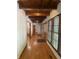 Well-lit hallway featuring hardwood floors, exposed beams, and natural light at 5530 Shawnee Trail South Dr, Indianapolis, IN 46220