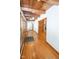 Charming hallway with hardwood floors and wood-paneled ceiling leading to a room with a fireplace at 5530 Shawnee Trail South Dr, Indianapolis, IN 46220