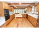Expansive kitchen with wood cabinetry, a central island, and large windows for natural lighting at 5530 Shawnee Trail South Dr, Indianapolis, IN 46220