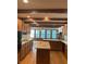 Open kitchen layout with an island, wood cabinetry, and large windows overlooking the backyard at 5530 Shawnee Trail South Dr, Indianapolis, IN 46220