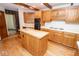 Kitchen features wood island and cabinets, plus white countertops and modern gas stovetop at 5530 Shawnee Trail South Dr, Indianapolis, IN 46220