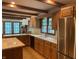 Spacious kitchen area with wood cabinets, stainless steel refrigerator and an island at 5530 Shawnee Trail South Dr, Indianapolis, IN 46220