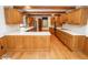 Spacious kitchen features wood cabinets, white countertops, hardwood floors, and a central island at 5530 Shawnee Trail South Dr, Indianapolis, IN 46220