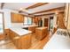 Bright kitchen showcases wood cabinets, white countertops, hardwood floors, and a center island at 5530 Shawnee Trail South Dr, Indianapolis, IN 46220