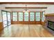 Open concept living room with wood floors, fireplace, and abundant windows at 5530 Shawnee Trail South Dr, Indianapolis, IN 46220