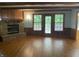 An airy living room boasting hardwood floors, a stone fireplace, exposed beams, and bright natural light at 5530 Shawnee Trail South Dr, Indianapolis, IN 46220