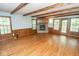 Bright living room featuring a stone fireplace, hardwood floors, and wood trim at 5530 Shawnee Trail South Dr, Indianapolis, IN 46220