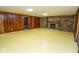 Living room featuring wood paneling, stone fireplace and ample lighting at 5530 Shawnee Trail South Dr, Indianapolis, IN 46220