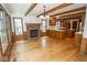 Living room with hardwood floors, fireplace, and open to the kitchen at 5530 Shawnee Trail South Dr, Indianapolis, IN 46220