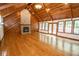 Large living room with hardwood floors, a stone fireplace, wood ceilings, and ample natural light at 5530 Shawnee Trail South Dr, Indianapolis, IN 46220