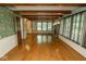 Spacious living room with hardwood floors, built-ins, fireplace, and large windows at 5530 Shawnee Trail South Dr, Indianapolis, IN 46220