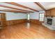 Cozy living room featuring hardwood floors, wood trim, and a stone fireplace at 5530 Shawnee Trail South Dr, Indianapolis, IN 46220