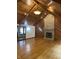 Charming room with vaulted ceilings, hardwood floors, and a stone fireplace at 5530 Shawnee Trail South Dr, Indianapolis, IN 46220