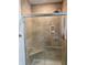 Shower featuring decorative tile and glass door at 5530 Shawnee Trail South Dr, Indianapolis, IN 46220