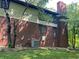 Side view of the home featuring brick, vinyl siding, an air conditioning unit and partial landscaping at 5530 Shawnee Trail South Dr, Indianapolis, IN 46220