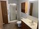 Bathroom featuring a shower, toilet, vanity, and wood cabinets at 5632 Spring Mist Cir, Indianapolis, IN 46237
