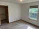 Bedroom featuring a closet, window with backyard view, and neutral carpet at 5632 Spring Mist Cir, Indianapolis, IN 46237