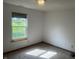 Bedroom with window view of the backyard, neutral carpet and light fixture at 5632 Spring Mist Cir, Indianapolis, IN 46237