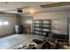 Garage featuring an automatic door opener, pegboard, shelves, and concrete flooring at 5632 Spring Mist Cir, Indianapolis, IN 46237