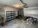 Garage with an automatic door opener, pegboard, shelves, and concrete flooring at 5632 Spring Mist Cir, Indianapolis, IN 46237