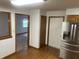 Kitchen layout with oak cabinets, stainless steel refrigerator, and doorway to adjacent spaces at 5632 Spring Mist Cir, Indianapolis, IN 46237