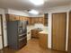 Functional kitchen featuring oak cabinets, stainless steel refrigerator, and plenty of counter space at 5632 Spring Mist Cir, Indianapolis, IN 46237