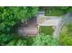 Aerial view showcasing a charming home with a brown roof nestled among lush green trees, creating a serene and private setting at 5824 Wesley Rdg, Martinsville, IN 46151