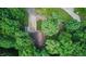 Aerial view showcasing a charming home nestled among lush green trees, revealing its serene and private surroundings at 5824 Wesley Rdg, Martinsville, IN 46151